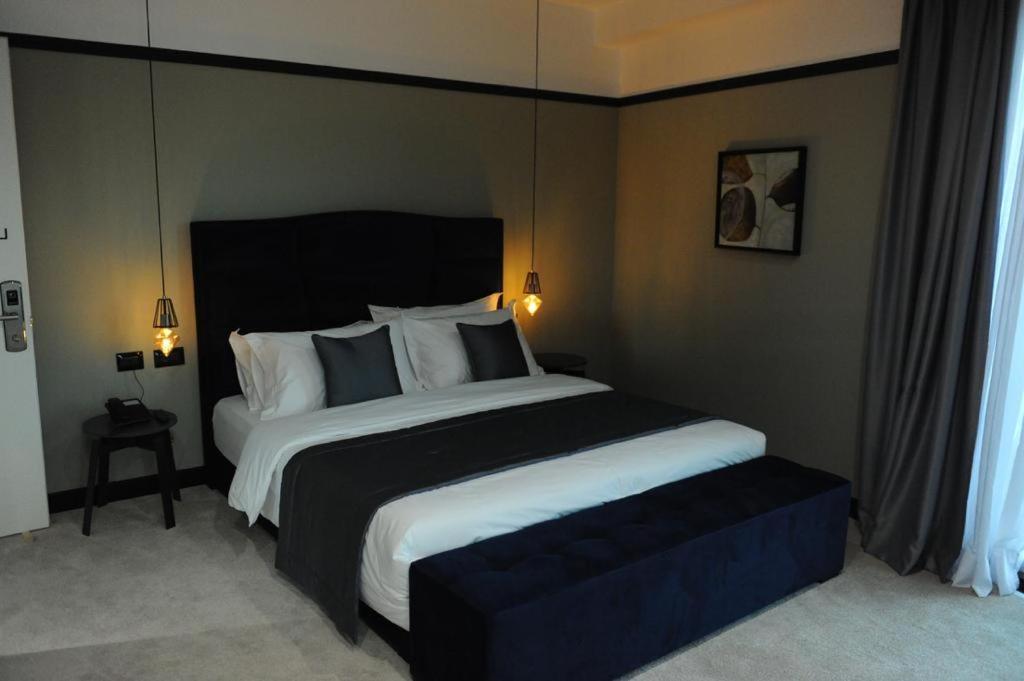 a bedroom with a large bed with a black headboard at Eurobushi Hotel in Kolgecaj
