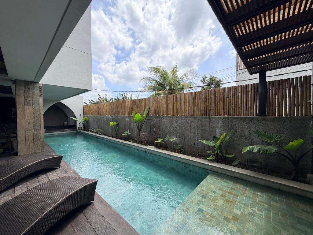 a swimming pool in the middle of a building at Kalpa Tree Co-living in Canggu