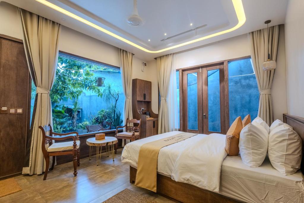 a bedroom with a bed and a large window at Villa Lumora Maldives in Rasdhoo