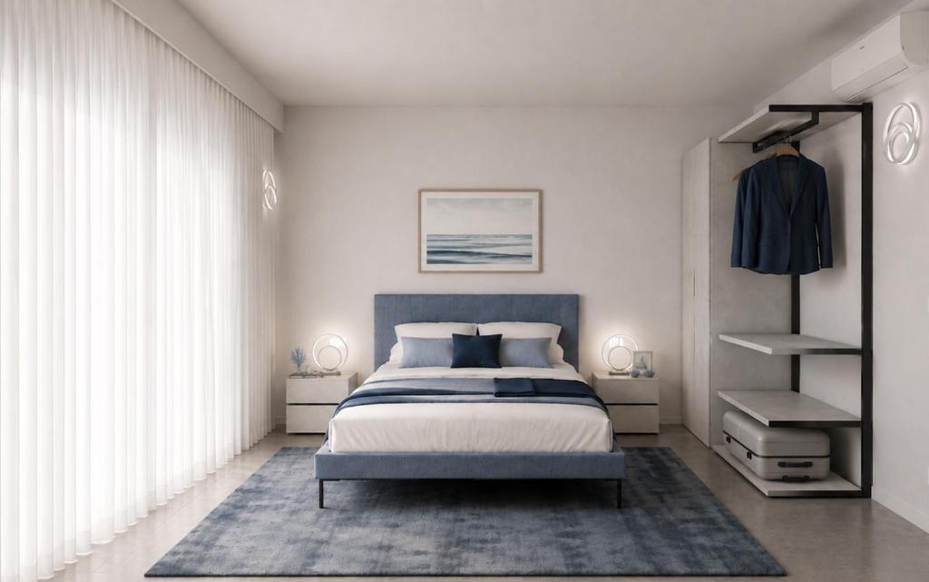 a bedroom with a king sized bed and white walls at SeaFrontBonassola in Bonassola