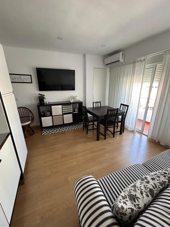a living room with a couch and a table at Corazón de Nerja in Nerja