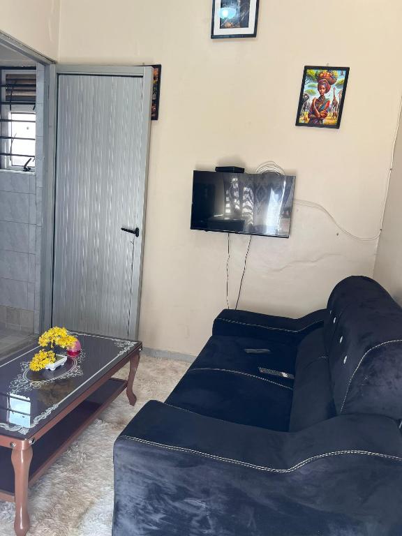 a living room with a blue couch and a table at Regeneration in Jinja