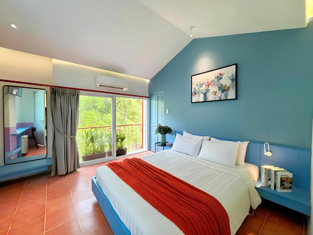 a bedroom with a large bed and a large window at Joi Home Beachfront in Vung Tau