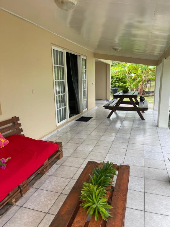 a patio with a bed and a picnic table at NAEHU TEMAUI A MATUANUI Lodge in Tiputa