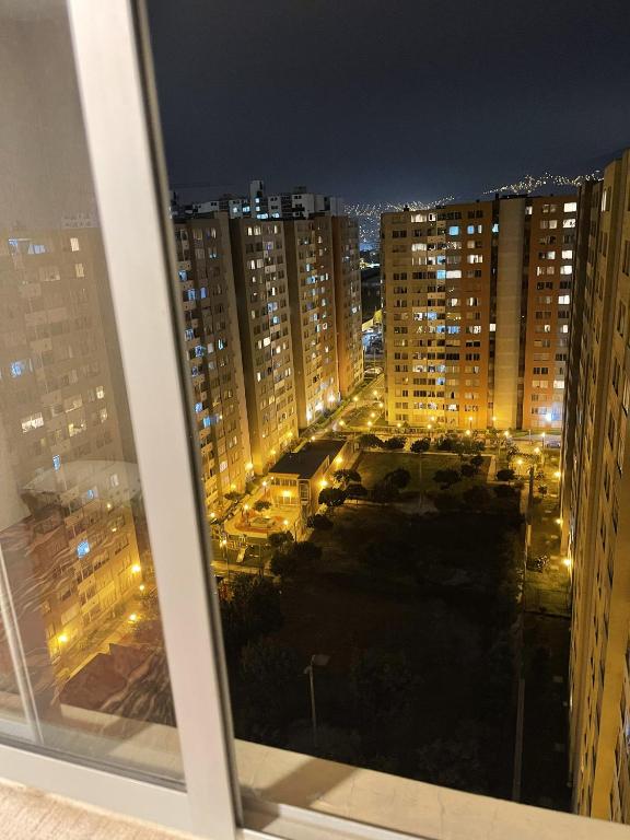 a view of a city at night from a window at Los Laureles -Executive Residence Departamento in Lima