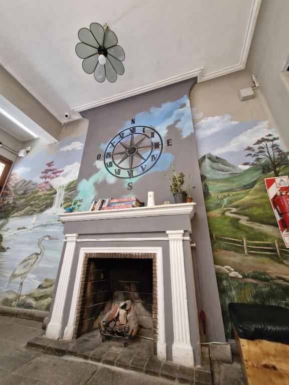 a living room with a fireplace with a clock above it at Why Not Nueva Cordoba in Córdoba