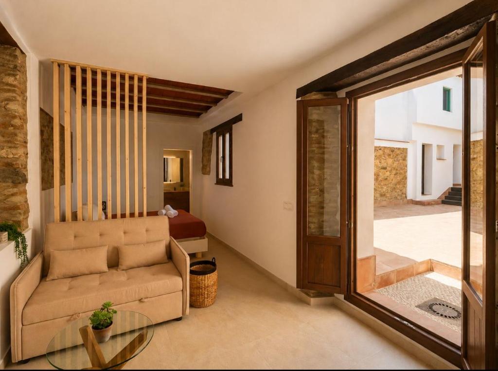 a living room with a chair and a glass table at Apartamento Torre in Cártama