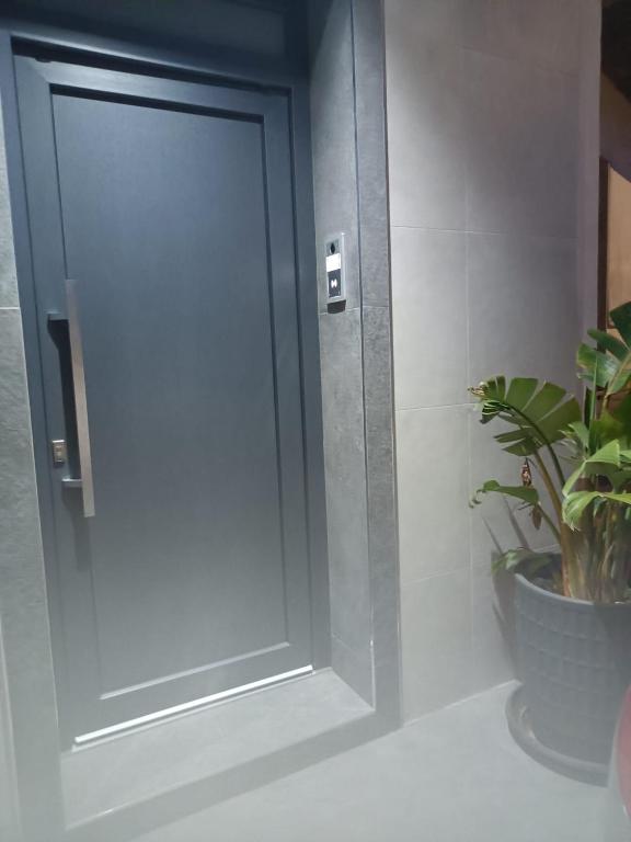 a door in a bathroom with a potted plant at La RIVISTA in Manduria