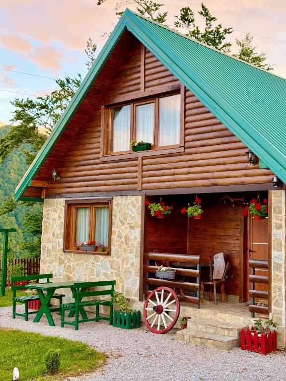 a log cabin with a bench and a table at Mountain Star House in Mojkovac