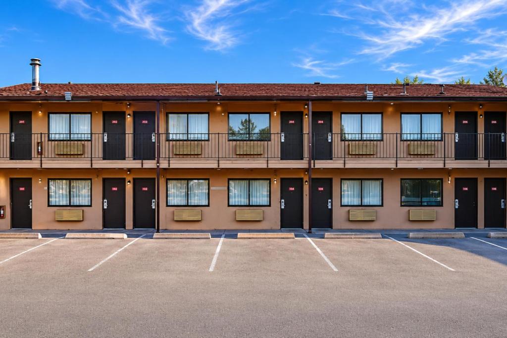 a building with a parking lot in front of it at Travel Inn By OYO Omaha in Millard
