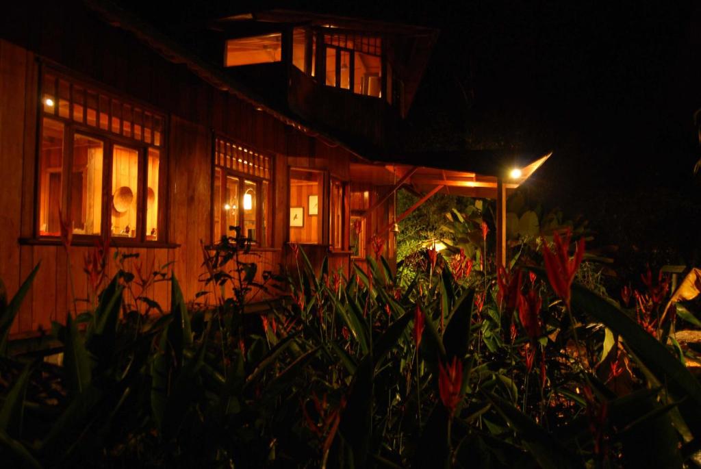 a house at night with plants in front of it at Mindo Garden Lodge and Wildlife Reserve in Mindo