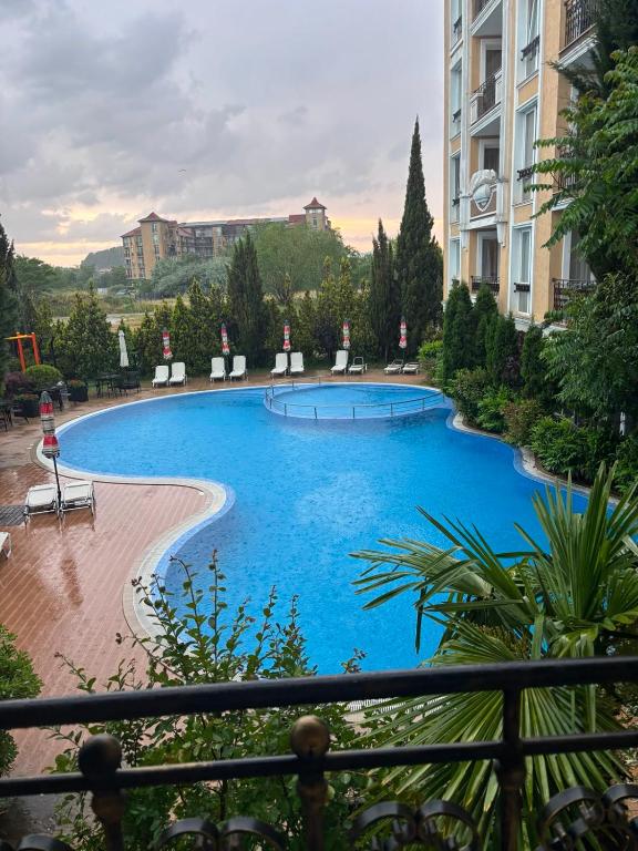 a large blue swimming pool in a building at Messembria Palace Bulgaria in Sunny Beach