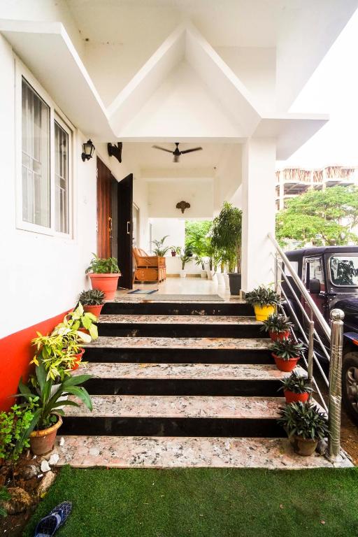 a house with stairs leading to the front yard at Mong Mao Manor in Guwahati