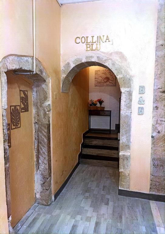 a staircase in a building with a sign that reads colunabu at Collina Blu in Cuglieri