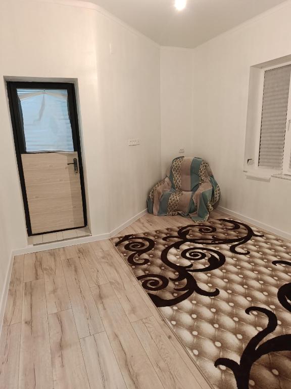 a living room with a chair and a rug at Sherine house in Tamga