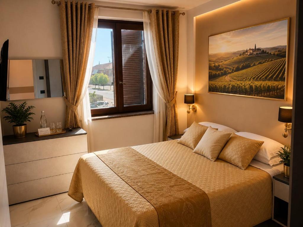 a bedroom with a bed and a window with a painting at Da Mario in Guarene