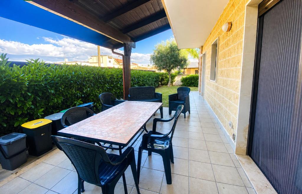 a table and chairs sitting on a patio at Casa Ulivo in Pulsano