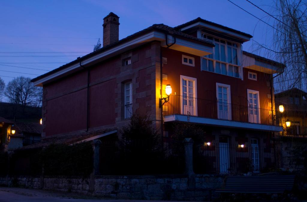 a house with a light on the side of it at Posada El Marqués De Trancadorio in La Virgen