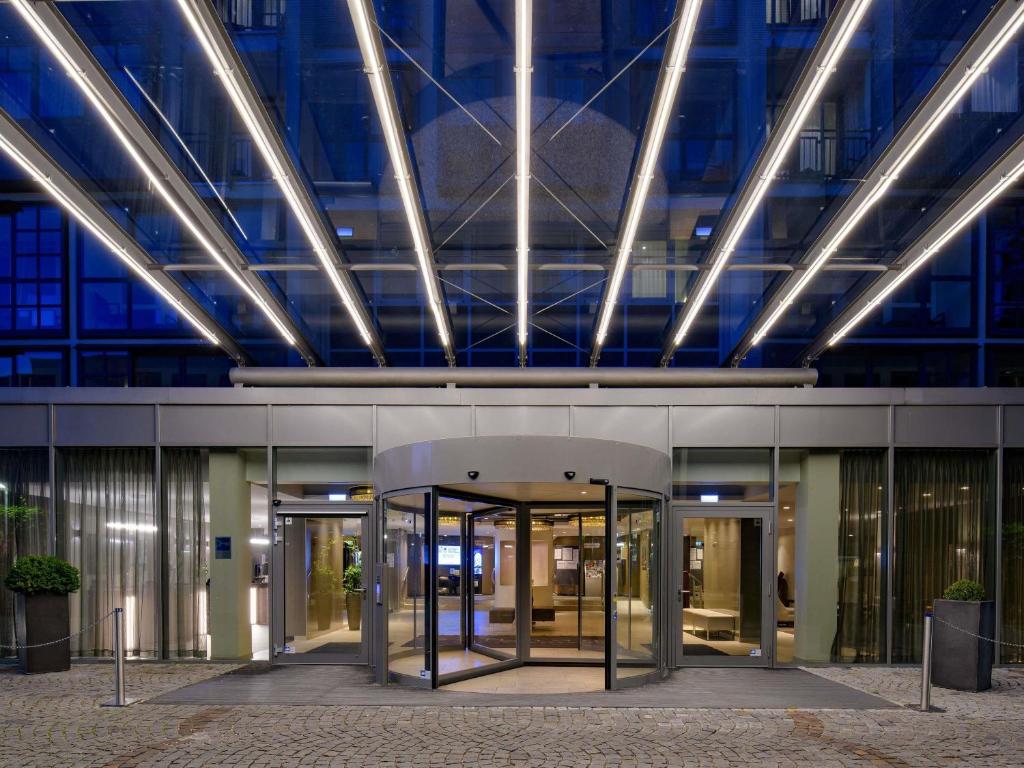 an office building with glass doors in front of it at Pullman Munich in Munich