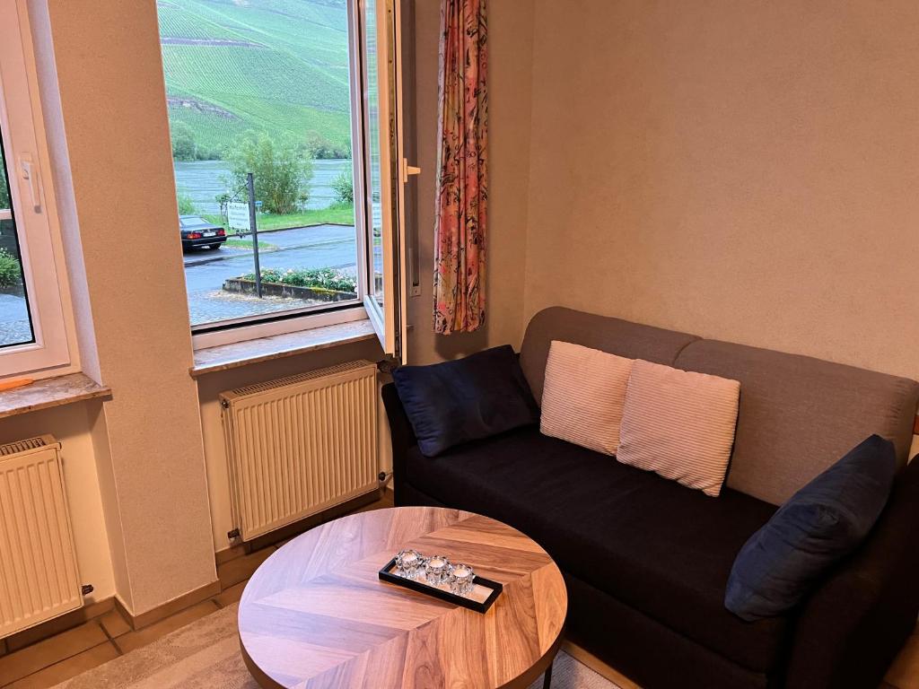 a living room with a couch and a table at Ferienwohnung 1 in Bernkastel-Kues