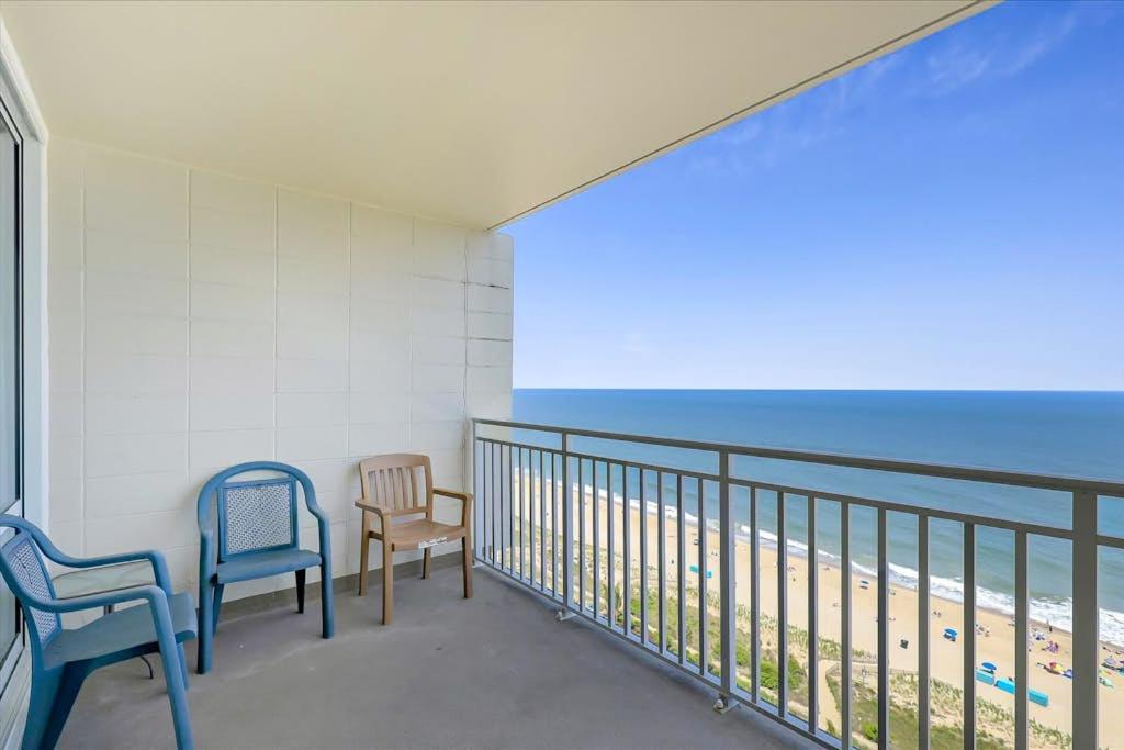a balcony with two chairs and a view of the beach at Carousel 1904 in Ocean City