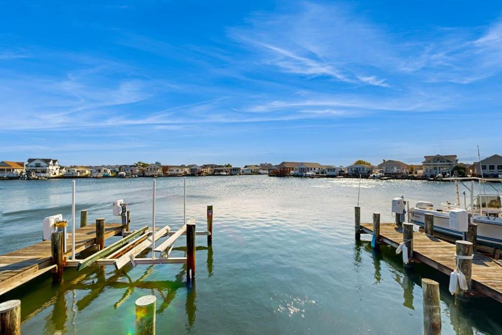 a dock with a boat in the water at Oyster Lane Hideout in Ocean City