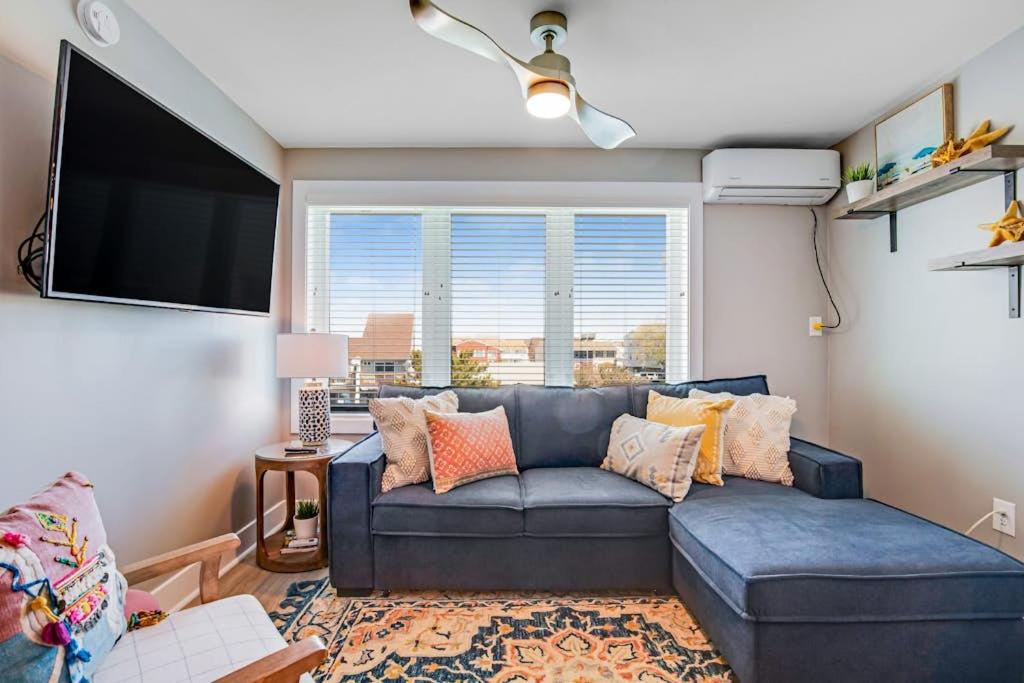 a living room with a couch and a flat screen tv at Boho Bayshore 42 in Ocean City
