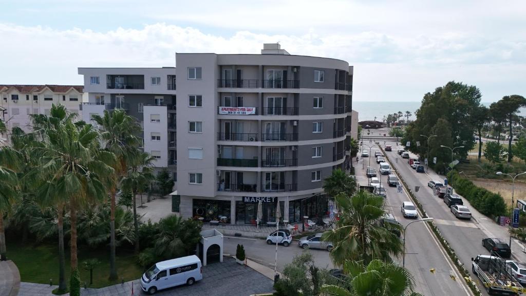 an apartment building on a city street with cars at Almare ApartHotel in Golem