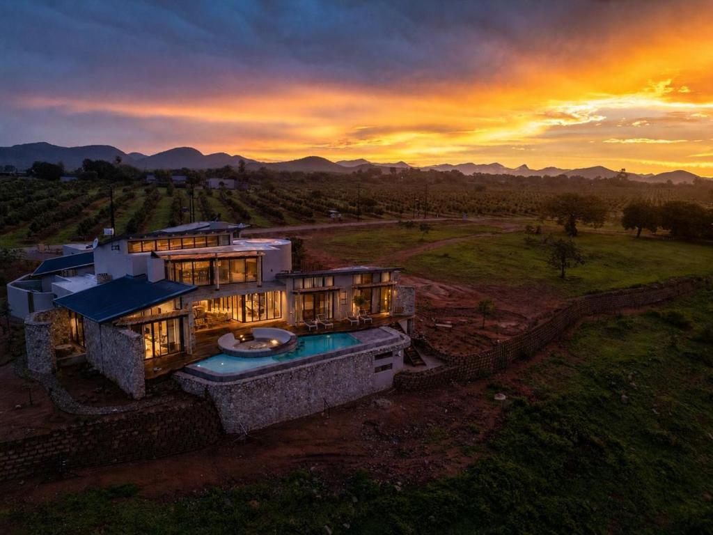 an aerial view of a house with a sunset at Izakithi River Villa in Malelane