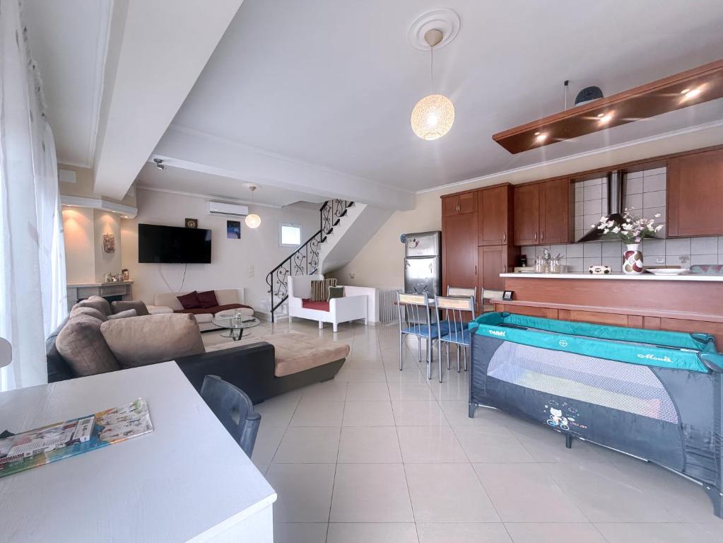 a living room and kitchen with a pool in it at An-Mary by vacapers in Iraklitsa