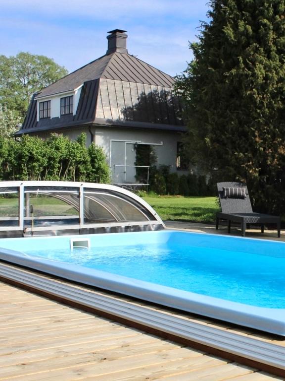 a swimming pool in front of a house at Villa Linnea in Hanko