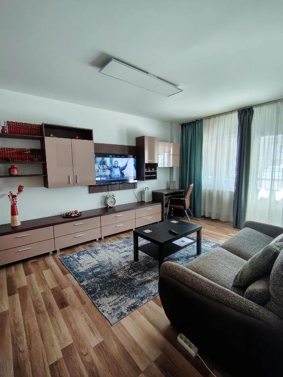 a living room with a couch and a tv at Adrian Home Mega in Ploieşti