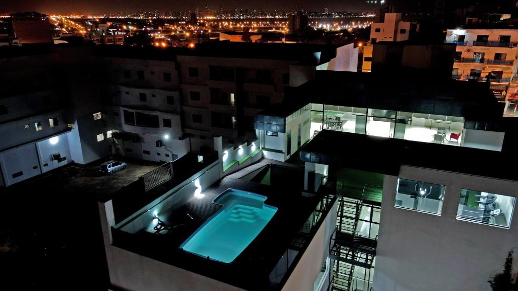a swimming pool in the middle of a building at night at Bella Vista Hotel - Encarnación in Encarnación