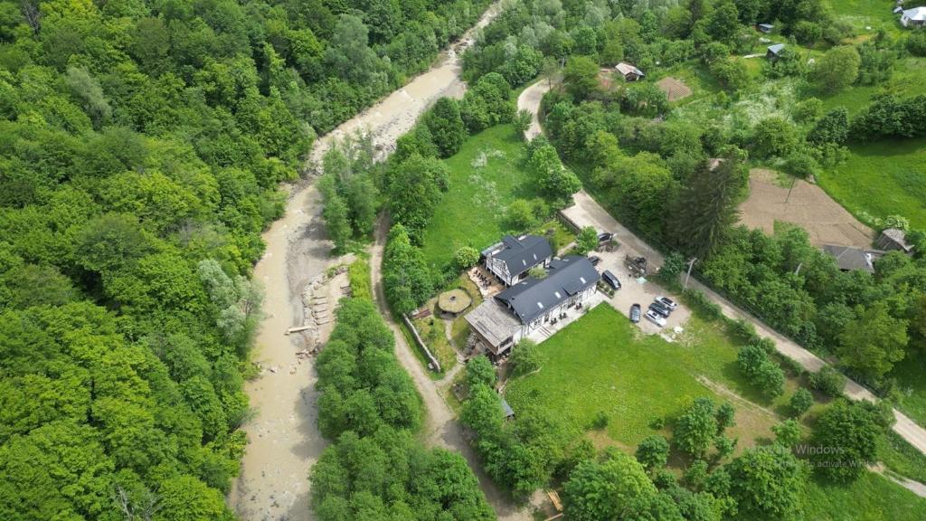 an aerial view of a house in the forest at OM Resort in Gura Teghii