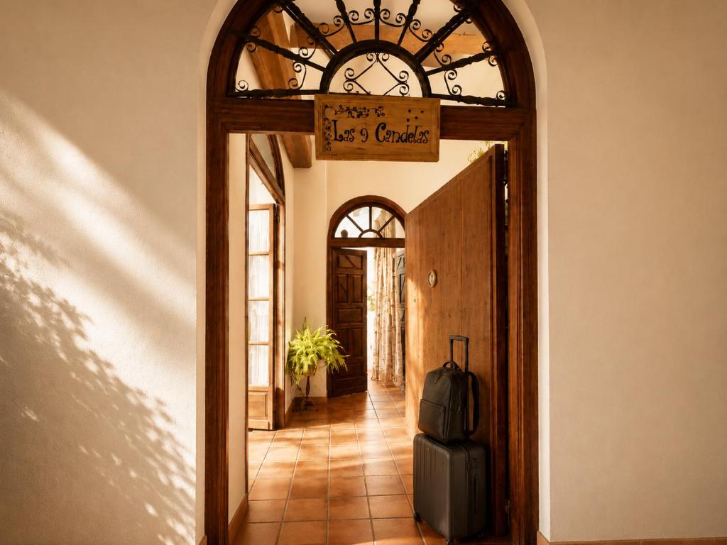 a door leading to a hallway with a suitcase at Las 9 Candelas alojamiento en el centro de Yecla in Yecla