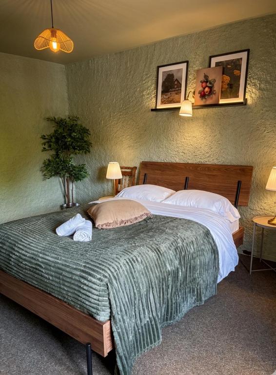 a bedroom with a large bed with two pillows at Relais du Moulin - Bed & Breakfast in Abreschviller