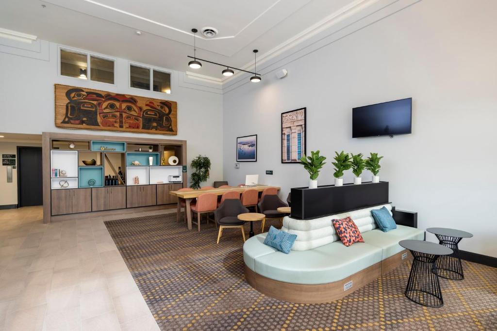 a living room with a couch and a table at Holiday Inn Victoria - Elk Lake by IHG in Victoria