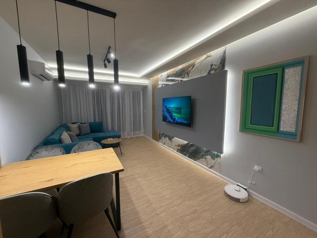 a living room with a blue couch and a table at RICH 2 Apartment in Plovdiv