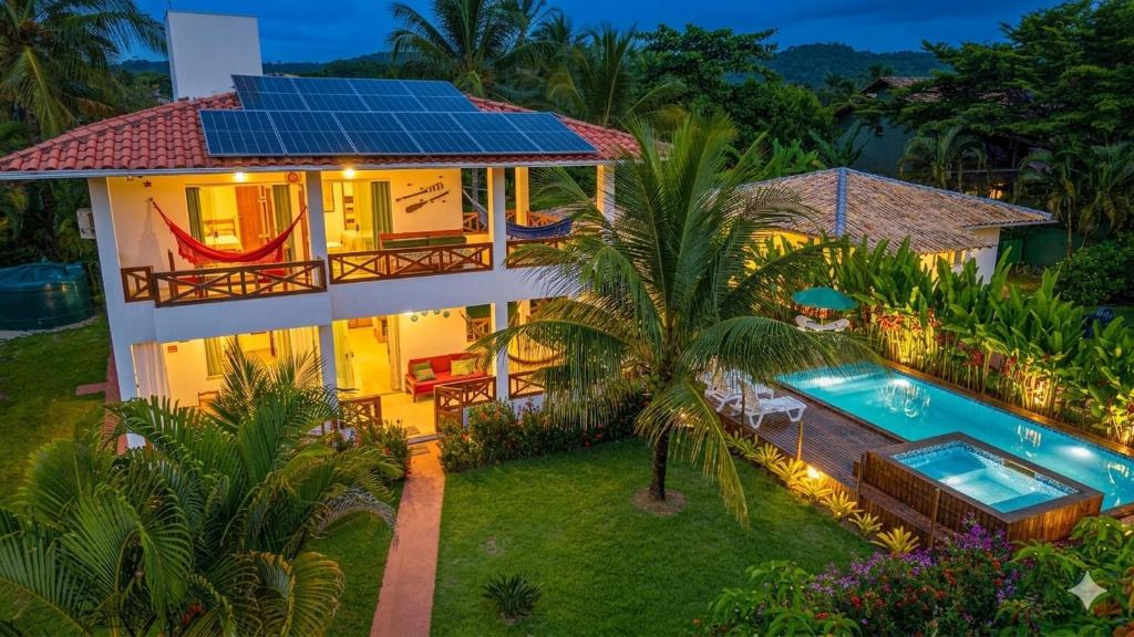 an aerial view of a house with solar panels on the roof at Casabela Sargi Serra Grande in Uruçuca