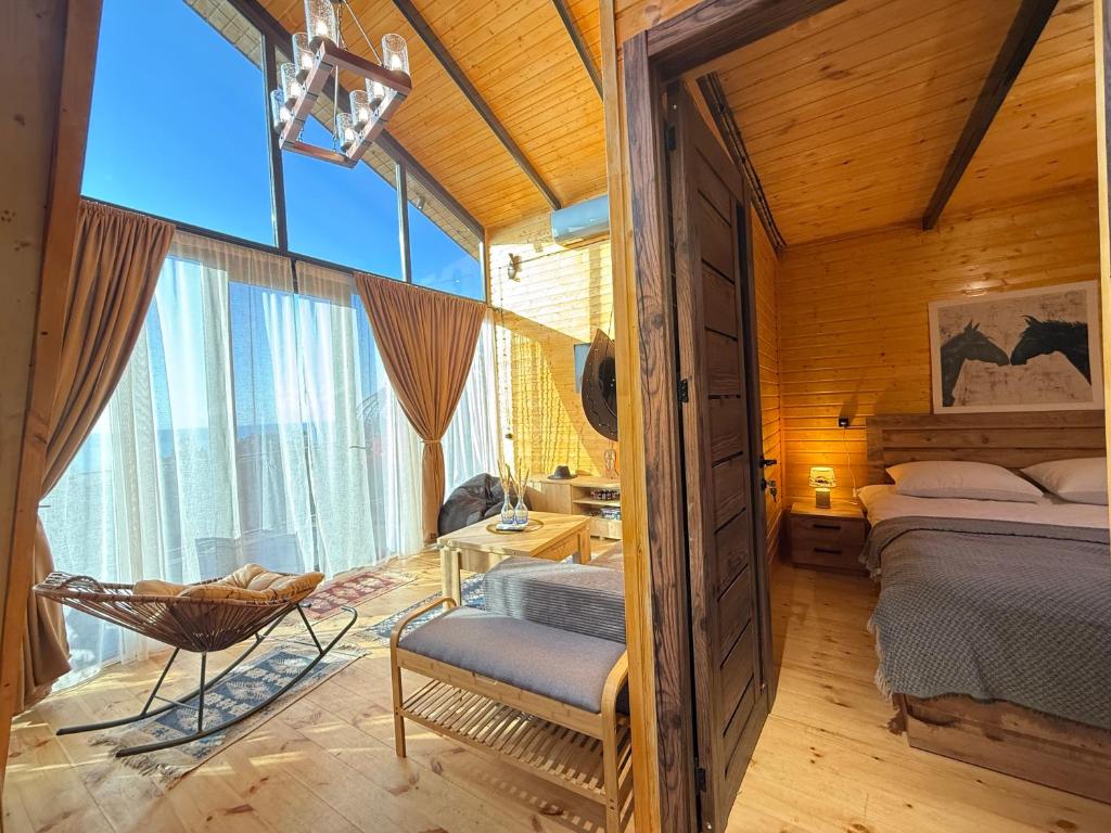 a bedroom with a bed and a chair in a room at West Coast Cottage Buknari in Buknari