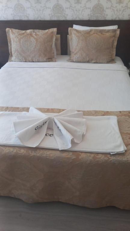 a bed with two beds with white towels on it at Şirince otel in Amasya
