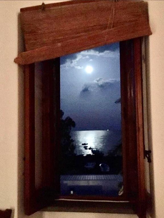 a window with a view of the moon and water at Casa Lorenzo in Stromboli