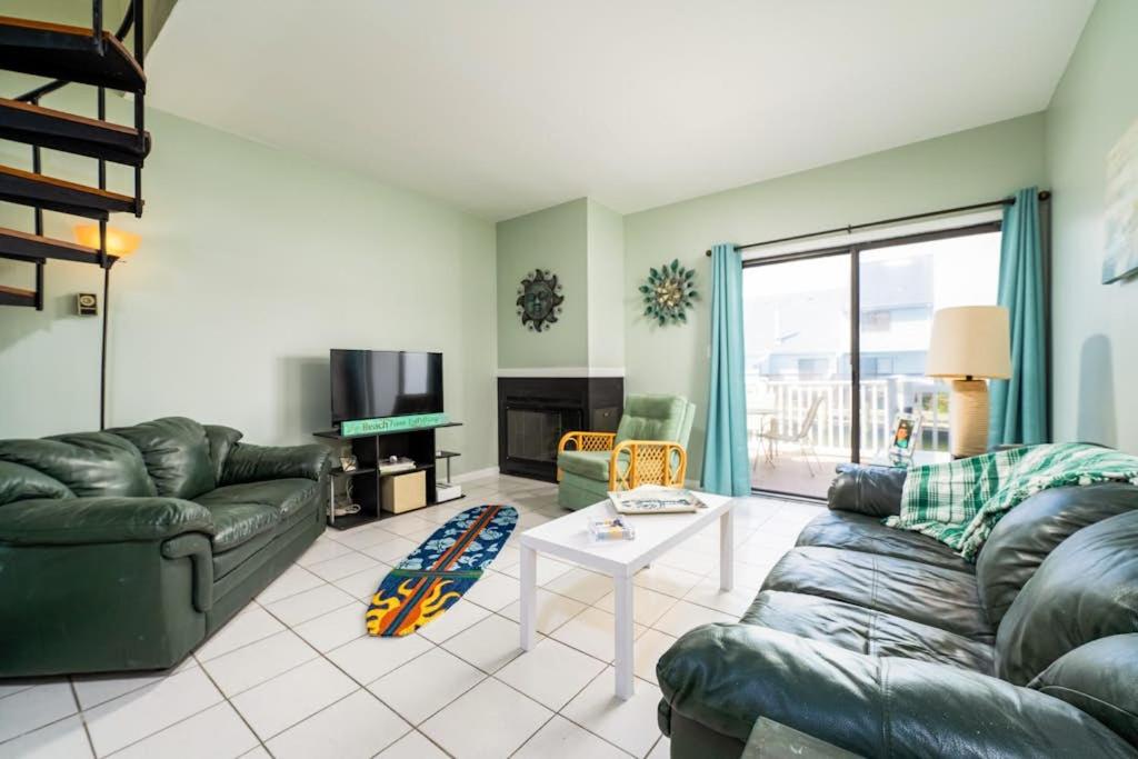 a living room with a couch and a table at Nassau Village 24 in Ocean City