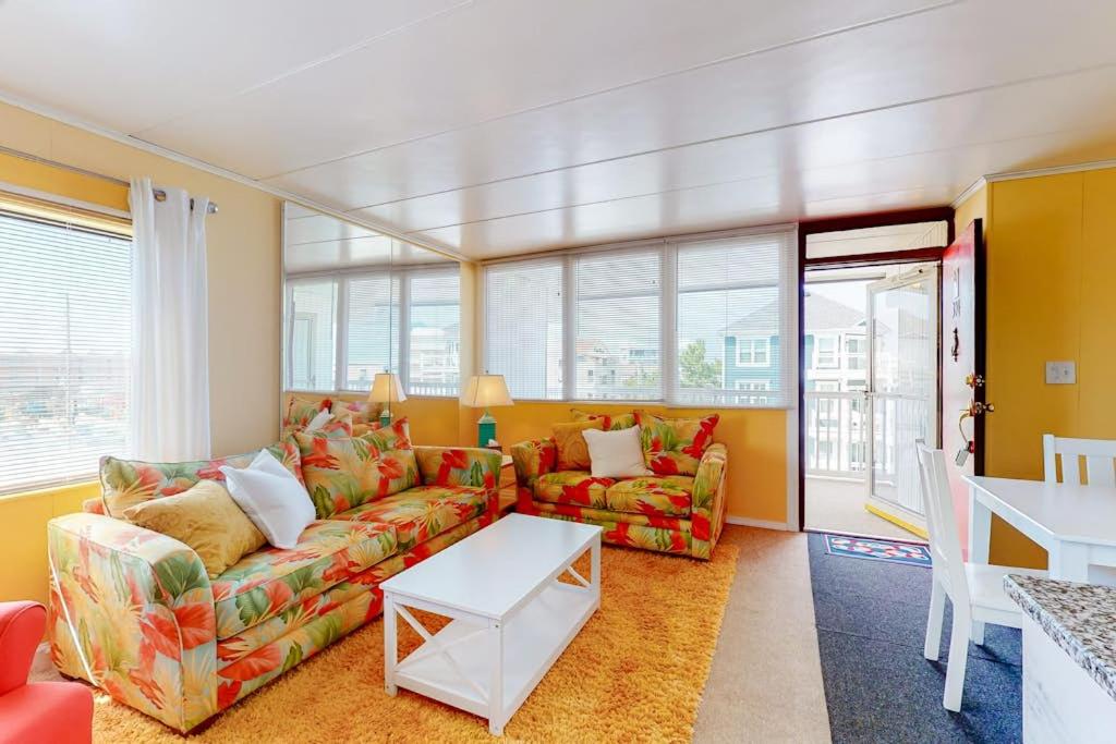 a living room with a couch and a table at Oceanblock on One Twenty-Four in Ocean City
