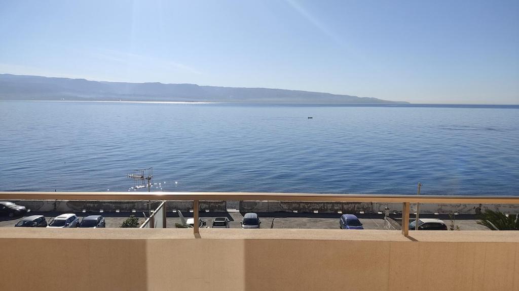 a balcony with a view of a large body of water at Brezza dello Stretto in Mili Marina