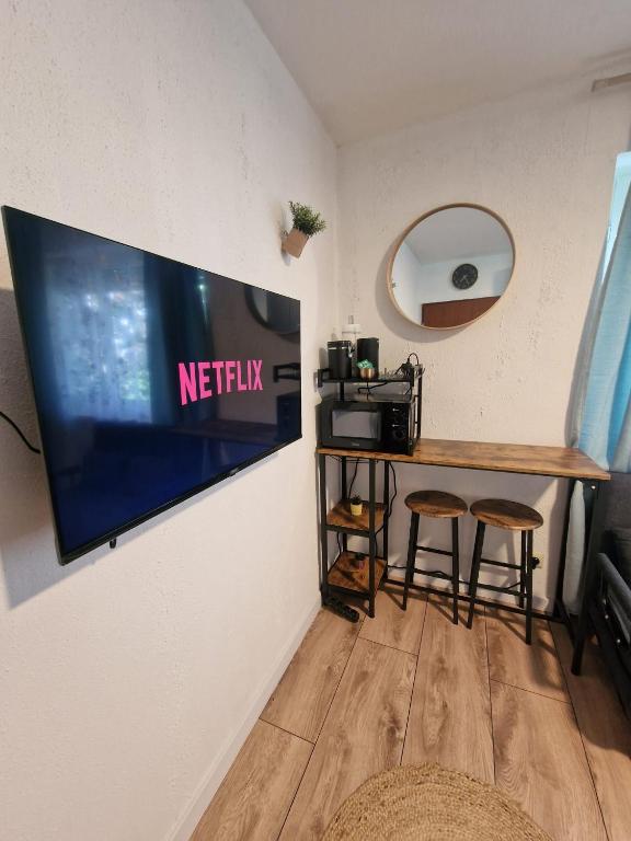 a television hanging on a wall in a room at Grimm Apartment 4 in Kassel