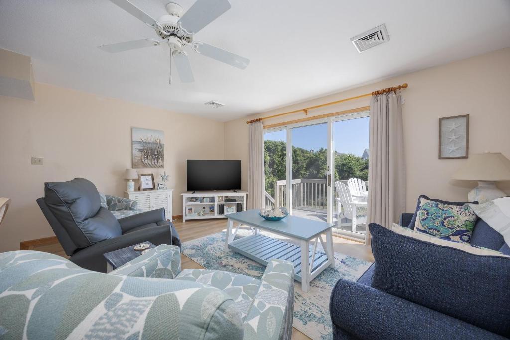 a living room with a couch and chairs and a tv at 4218 - The Scotts' SandBar in Duck