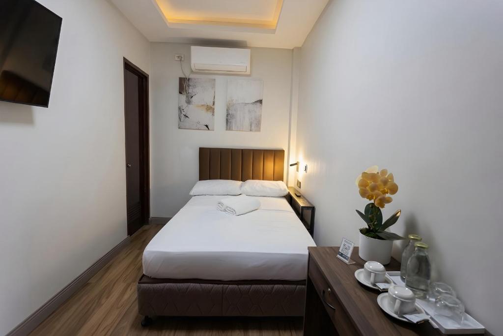 a hotel room with a bed and a table with dishes at Locale District Boutique Hotel in Quezon