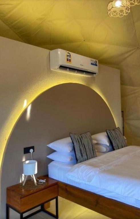 a bedroom with two beds and a heater on the wall at Bedouin Camp&tour in Wadi Rum