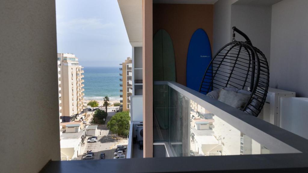 a balcony with surfboards on the side of a building at The Surf - Rocha Tower in Portimão